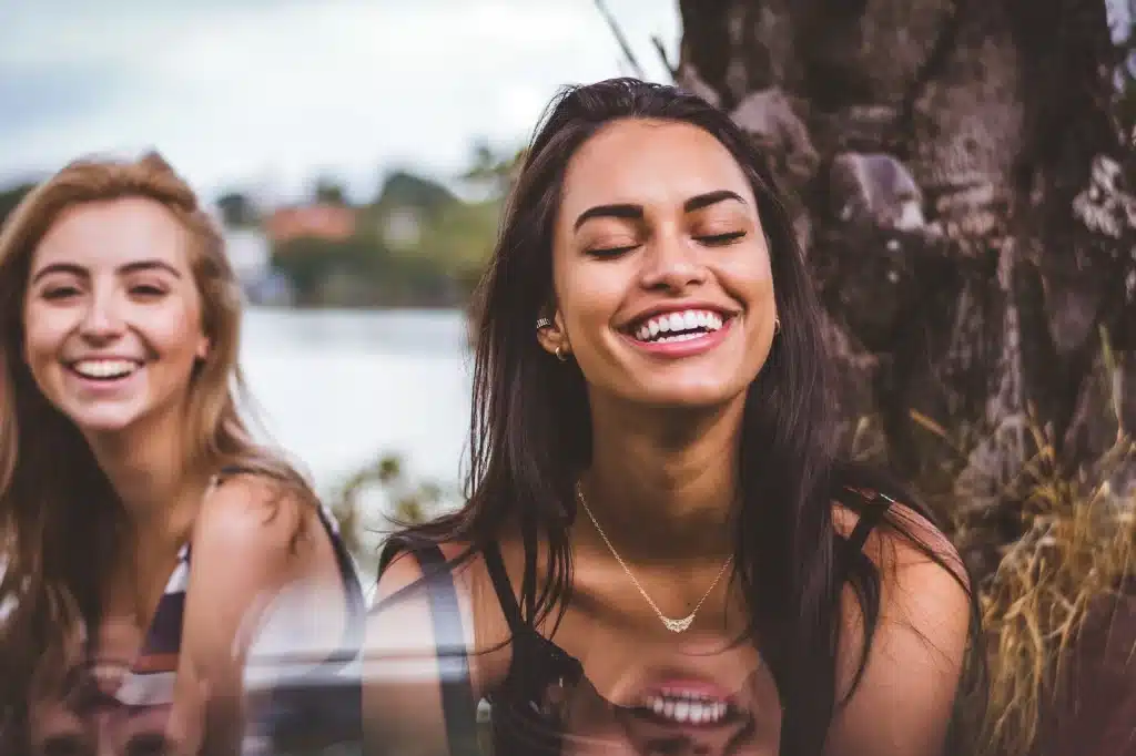 two women smiling in nature