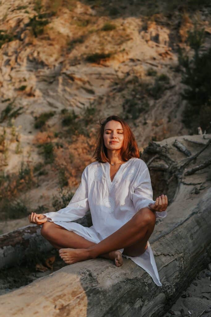 a woman meditating in nature