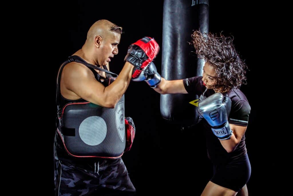 woman and a man boxing together