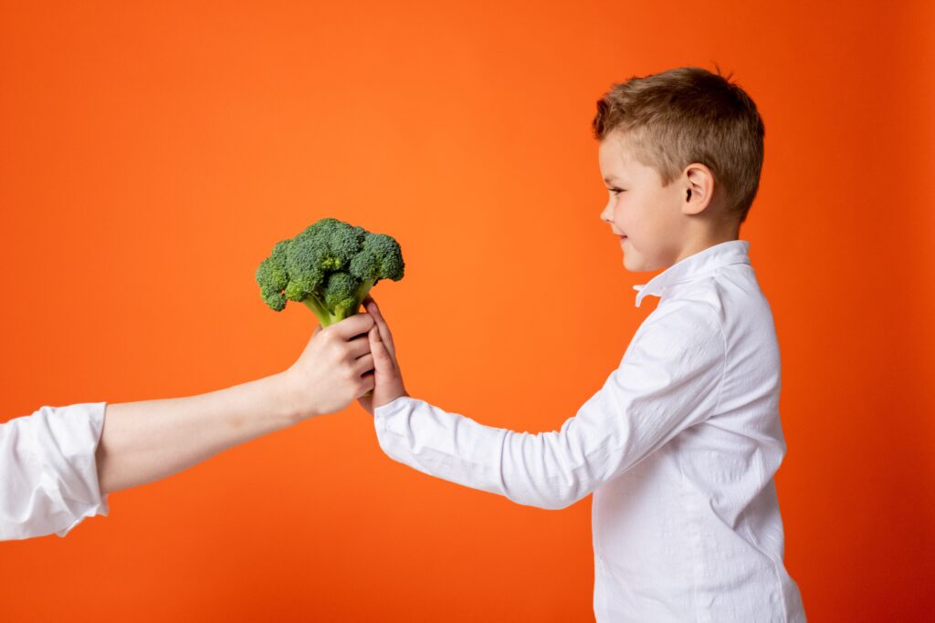 kid receiving a broccoli