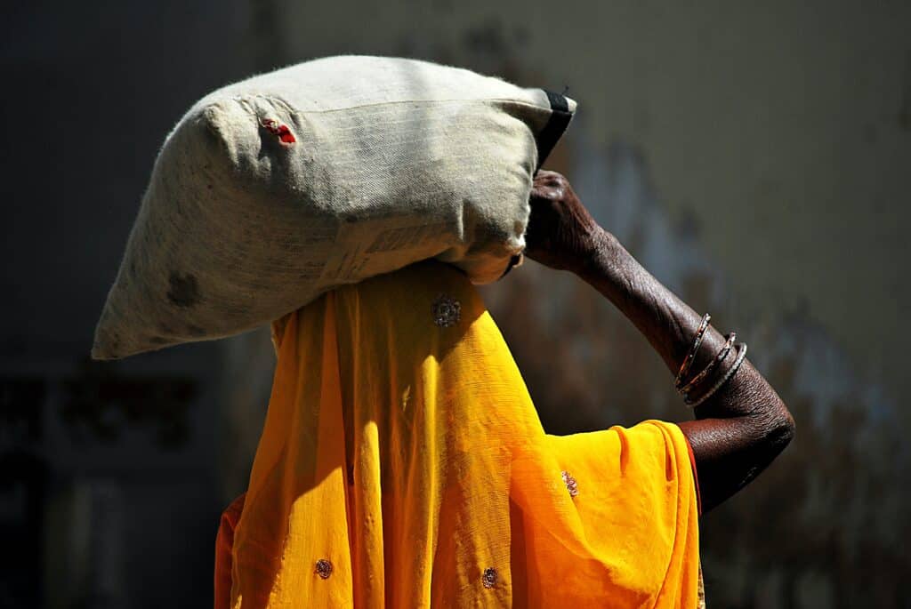 a African woman holding a bag over her head